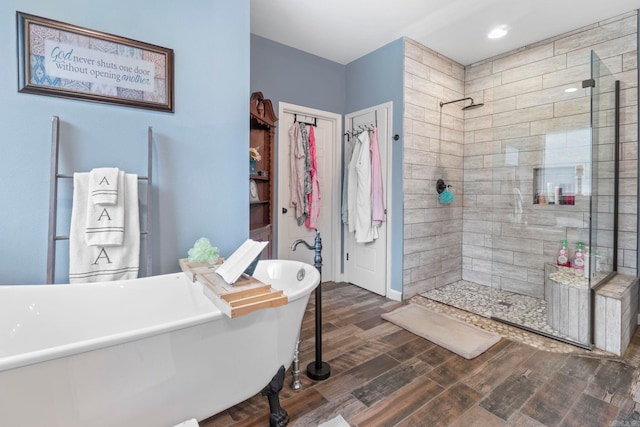 10820 W Sardis Rd, Bauxite, AR 72011 - full bath with tiled shower, wood finished floors, a freestanding bath, and a spacious closet