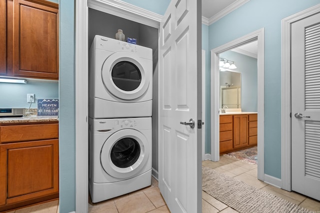 640 Ariridge Rd Unit D6, Hot Springs, AR 71913 - laundry room with stacked washer / drying machine, crown molding, light tile patterned floors, and baseboards
