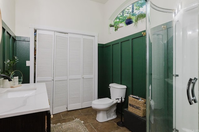 1112 Lawrence Ln, Benton, AR 72019 - full bathroom featuring a closet, a shower stall, vanity, toilet, and wainscoting
