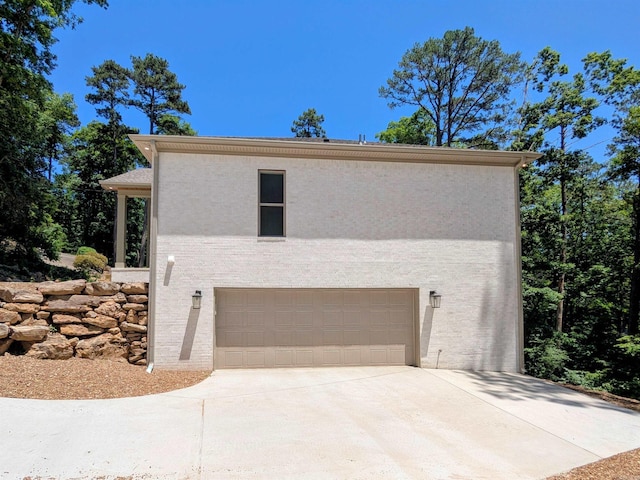 80 Stone Cir, Greers Ferry, AR 72067 - view of side of home featuring driveway, stucco siding, and a garage