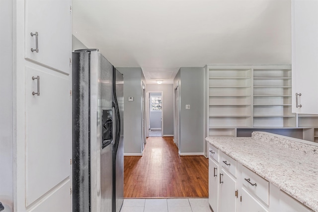 64 Castleberry Rd, Greenbrier, AR 72058 - kitchen featuring stainless steel refrigerator with ice dispenser, baseboards, light wood-style floors, white cabinets, and light stone counters