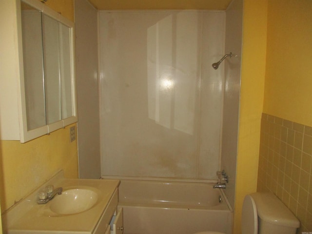 1407 E 38th St, Little Rock, AR 72206 - bathroom with toilet, vanity, tile walls, and  shower combination