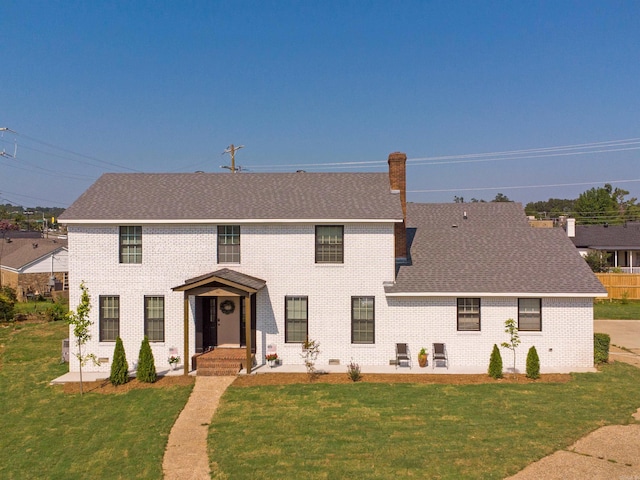 15 Brandywine Ln, Little Rock, AR 72227 - colonial house with brick siding, a front lawn, roof with shingles, and a chimney