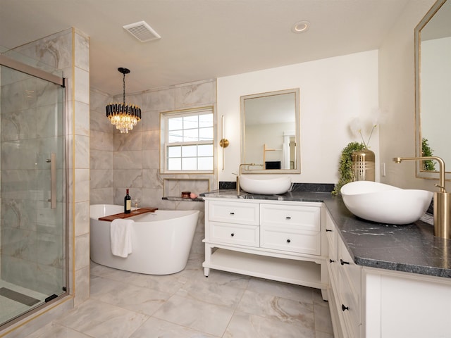 15 Brandywine Ln, Little Rock, AR 72227 - bathroom with double vanity, a stall shower, a soaking tub, marble finish flooring, and tile walls