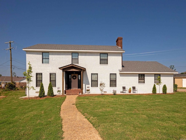 15 Brandywine Ln, Little Rock, AR 72227 - colonial inspired home featuring brick siding, a front yard, and a chimney