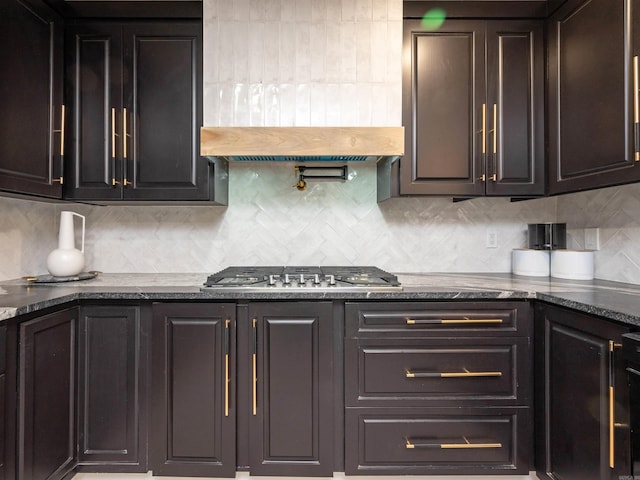 15 Brandywine Ln, Little Rock, AR 72227 - kitchen featuring custom range hood, tasteful backsplash, dark stone countertops, and stainless steel gas cooktop