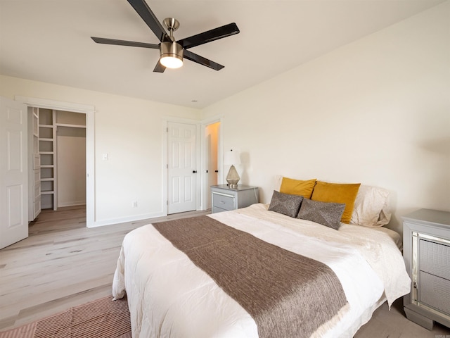 15 Brandywine Ln, Little Rock, AR 72227 - bedroom with light wood-style floors, baseboards, ceiling fan, a spacious closet, and a closet
