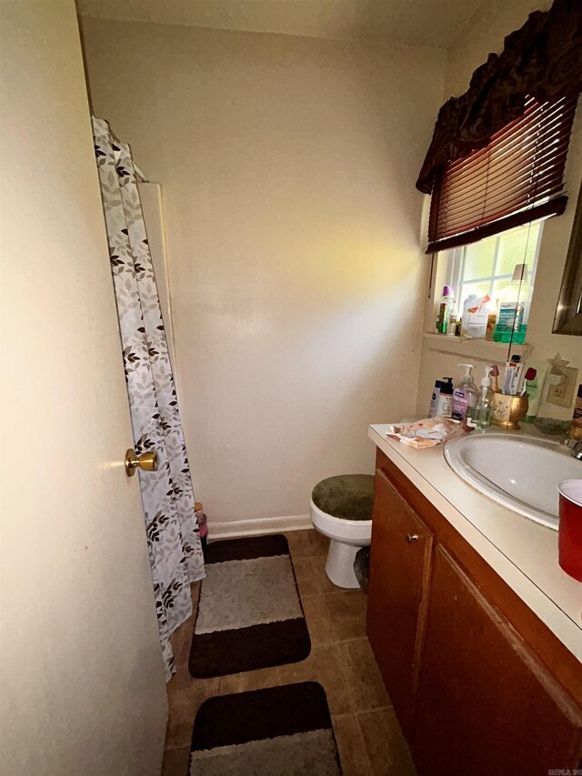 bathroom with vanity, toilet, tile patterned flooring, and a shower with shower curtain