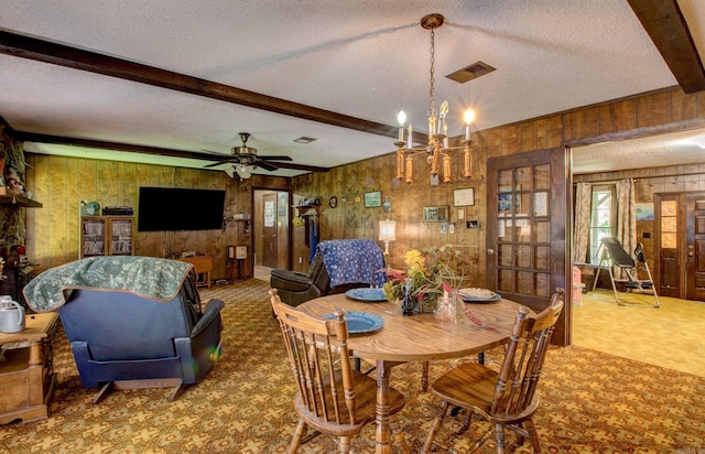 826 Carson Bridge Rd, Lonoke, AR 72086 - dining space with wooden walls, beamed ceiling, a textured ceiling, carpet, and a chandelier
