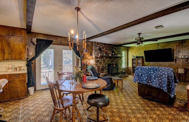 826 Carson Bridge Rd, Lonoke, AR 72086 - dining area with wood walls, a textured ceiling, beamed ceiling, plenty of natural light, and french doors