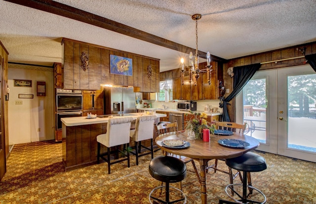 826 Carson Bridge Rd, Lonoke, AR 72086 - dining room featuring a textured ceiling, beam ceiling, wooden walls, and a chandelier
