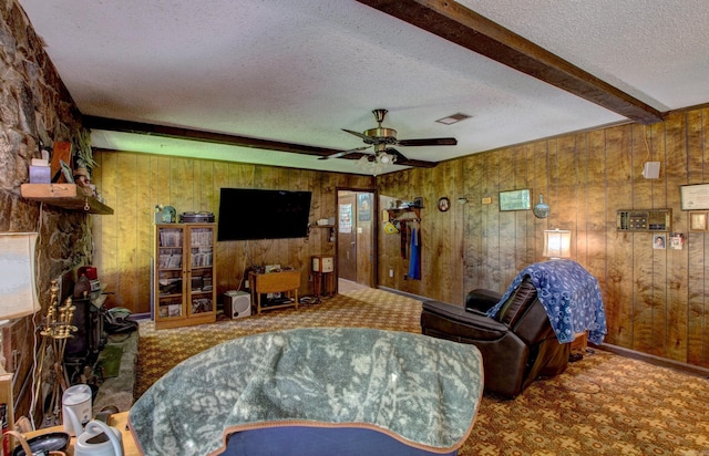 826 Carson Bridge Rd, Lonoke, AR 72086 - living area featuring a textured ceiling, wooden walls, carpet, and ceiling fan