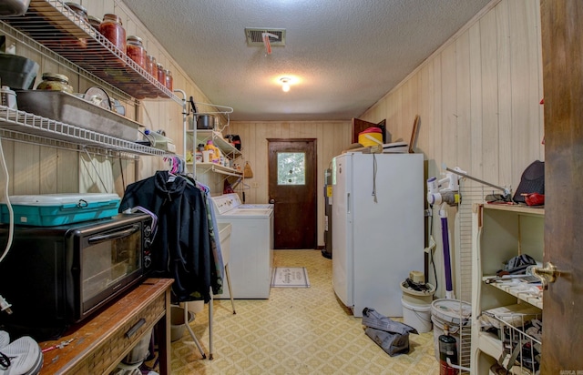 826 Carson Bridge Rd, Lonoke, AR 72086 - laundry room featuring independent washer and dryer, wood walls, a textured ceiling, and water heater