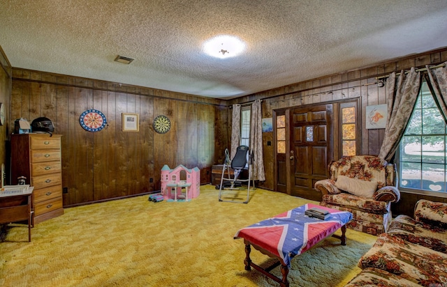 826 Carson Bridge Rd, Lonoke, AR 72086 - recreation room with a textured ceiling, wood walls, and carpet