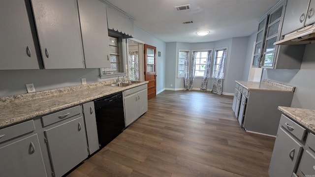 401 W S St, Benton, AR 72015 - kitchen with black dishwasher, a sink, dark wood-style flooring, light countertops, and baseboards