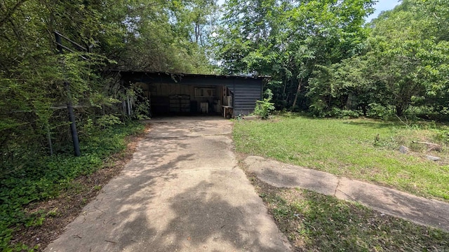 401 W S St, Benton, AR 72015 - view of outdoor structure with driveway and a carport