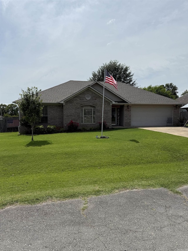 605 Shani Dr, Beebe, AR 72012 - single story home with a garage, concrete driveway, roof with shingles, and a front yard