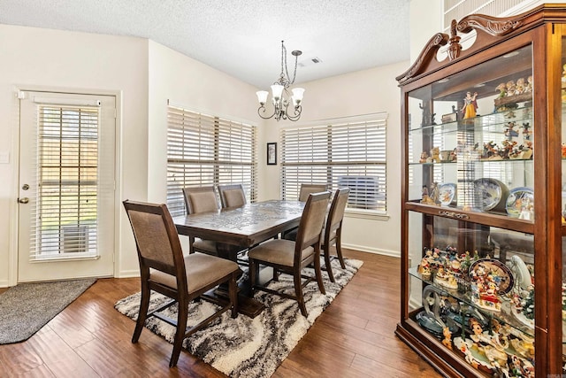 2806 Sundance Cir, Benton, AR 72015 - dining area with a chandelier, wood finished floors, a textured ceiling, and baseboards