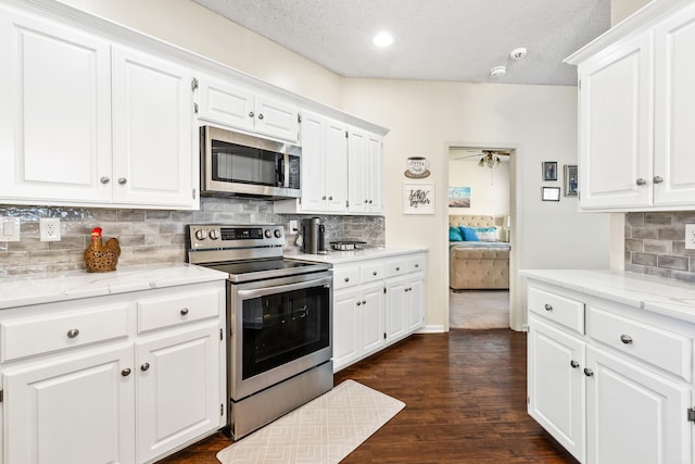 2806 Sundance Cir, Benton, AR 72015 - kitchen featuring appliances with stainless steel finishes, backsplash, white cabinetry, light stone counters, and a textured ceiling