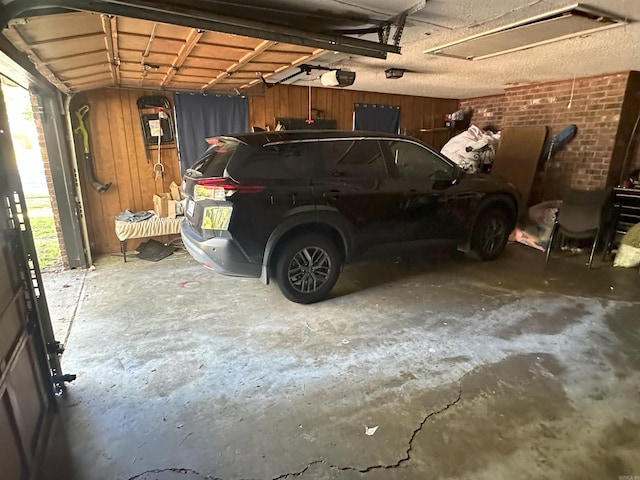 6625 Chateau Dr, Little Rock, AR 72209 - garage with wood walls and a garage door opener