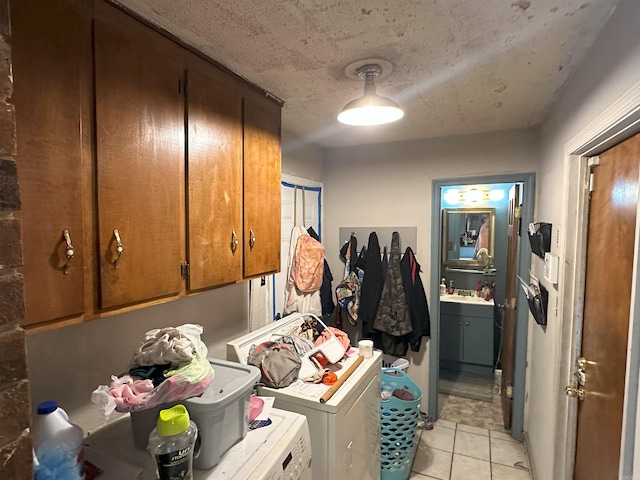 6625 Chateau Dr, Little Rock, AR 72209 - laundry area featuring cabinet space, light tile patterned floors, and washer and dryer