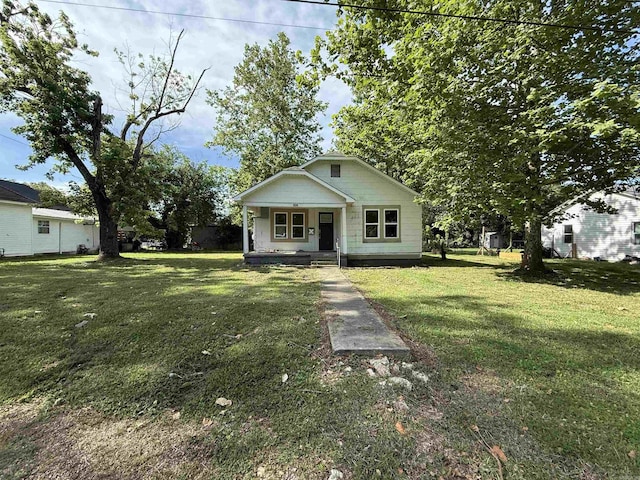 414 E 1st St, Rector, AR 72461 - bungalow-style house featuring a porch and a front yard