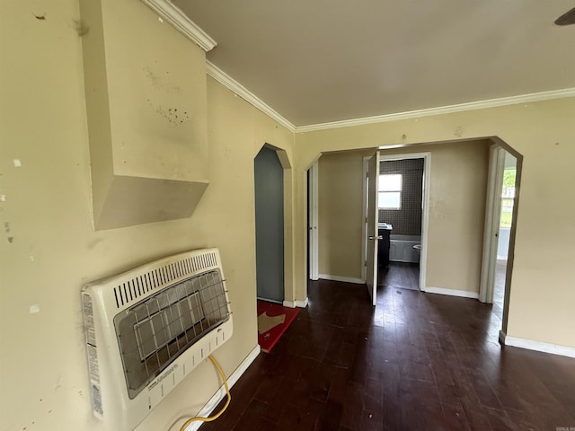 414 E 1st St, Rector, AR 72461 - unfurnished living room featuring heating unit, arched walkways, ornamental molding, baseboards, and hardwood / wood-style floors