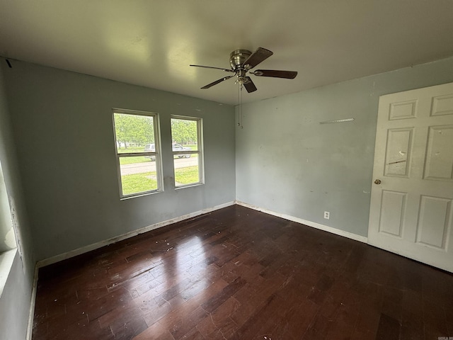 414 E 1st St, Rector, AR 72461 - spare room featuring a ceiling fan, dark wood-style floors, and baseboards