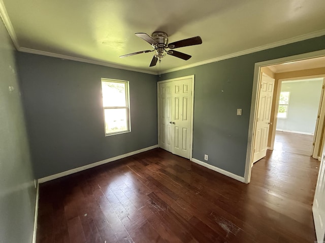 414 E 1st St, Rector, AR 72461 - unfurnished bedroom with multiple windows, dark wood-style flooring, baseboards, a closet, and crown molding