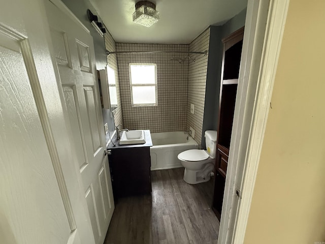 414 E 1st St, Rector, AR 72461 - bathroom featuring vanity, toilet, wood finished floors, and shower / washtub combination
