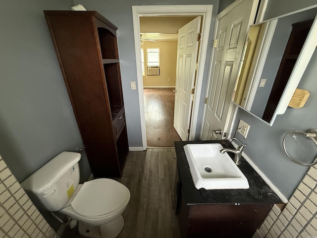 414 E 1st St, Rector, AR 72461 - bathroom featuring toilet, wood finished floors, vanity, baseboards, and ceiling fan