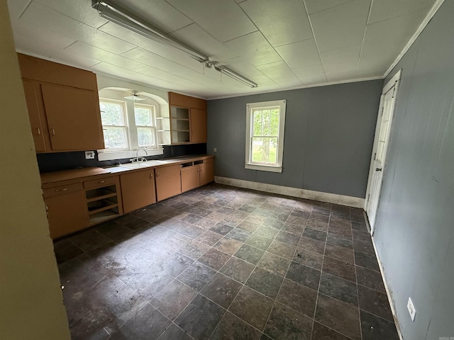 414 E 1st St, Rector, AR 72461 - kitchen with plenty of natural light, baseboards, open shelves, a sink, and ornamental molding