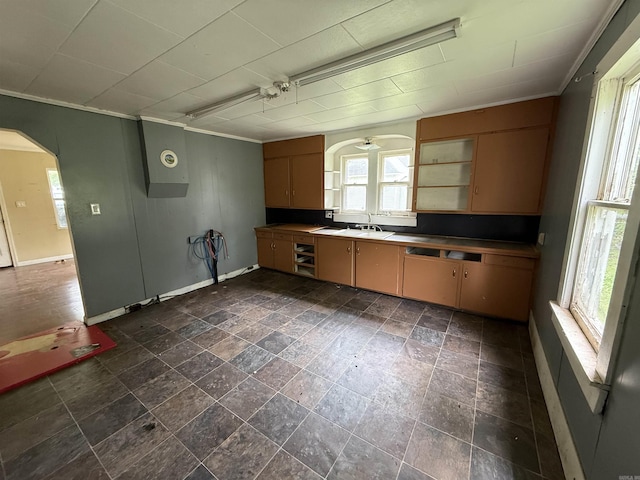 414 E 1st St, Rector, AR 72461 - kitchen featuring ornamental molding, plenty of natural light, baseboards, and arched walkways