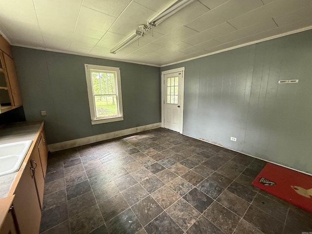 414 E 1st St, Rector, AR 72461 - unfurnished dining area featuring a sink, crown molding, dark stone finish floors, and baseboards