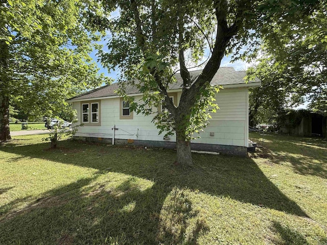 414 E 1st St, Rector, AR 72461 - view of side of home with a lawn and a shingled roof