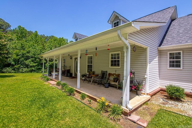 6221 Bray Dr, Benton, AR 72019 - rear view of house featuring roof with shingles, a lawn, and a porch