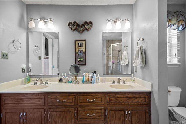6221 Bray Dr, Benton, AR 72019 - bathroom featuring a stall shower, double vanity, and toilet