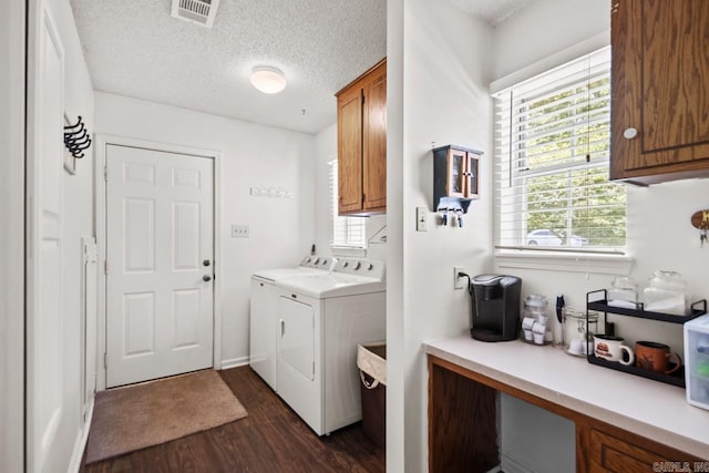 6221 Bray Dr, Benton, AR 72019 - laundry room with cabinet space, washing machine and clothes dryer, dark wood finished floors, and a textured ceiling