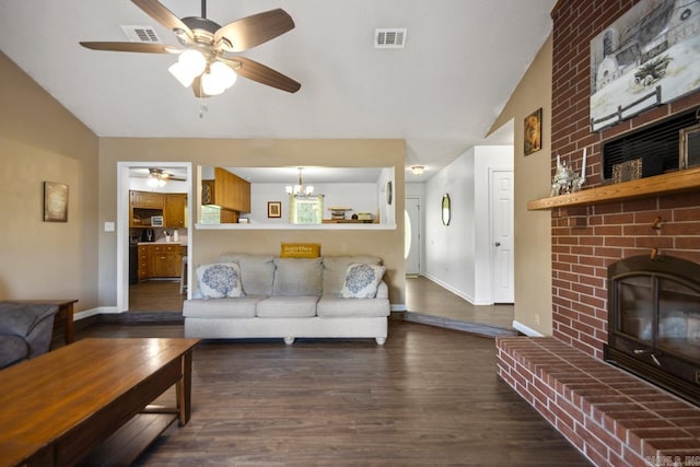 6221 Bray Dr, Benton, AR 72019 - living room featuring vaulted ceiling, a ceiling fan, wood finished floors, a fireplace, and a chandelier