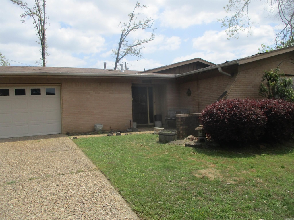 1521 Breckenridge Dr, Little Rock, AR 72227 - view of front of home with brick siding, an attached garage, driveway, a front lawn, and board and batten siding