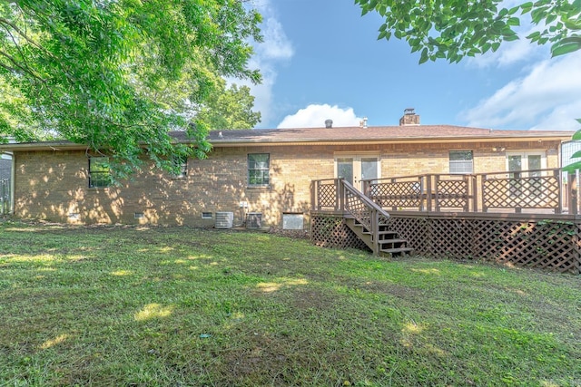 812 Glendale St, Jonesboro, AR 72401 - back of house featuring brick siding, a deck, a lawn, and a chimney