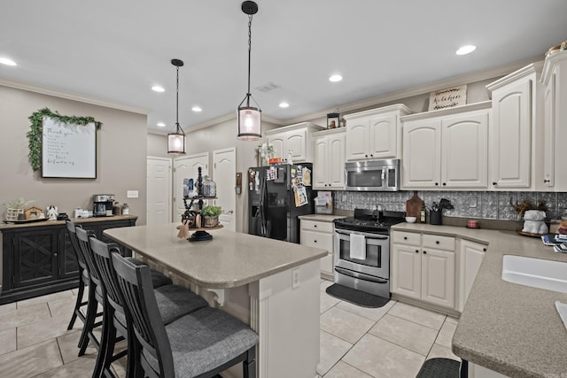 108 Chimney Rock Rd, Beebe, AR 72012 - kitchen featuring stainless steel appliances, ornamental molding, a center island, backsplash, and white cabinetry