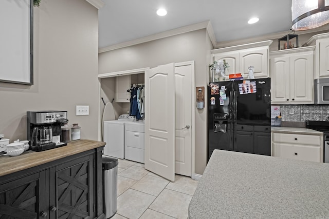 108 Chimney Rock Rd, Beebe, AR 72012 - kitchen featuring washing machine and dryer, black fridge with ice dispenser, ornamental molding, stainless steel microwave, and electric range oven