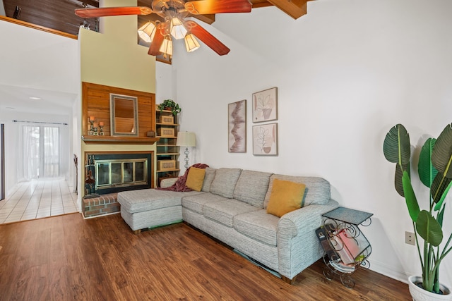 90 Silver Point Dr, Mount Ida, AR 71957 - living room featuring a fireplace, a towering ceiling, a ceiling fan, and wood finished floors