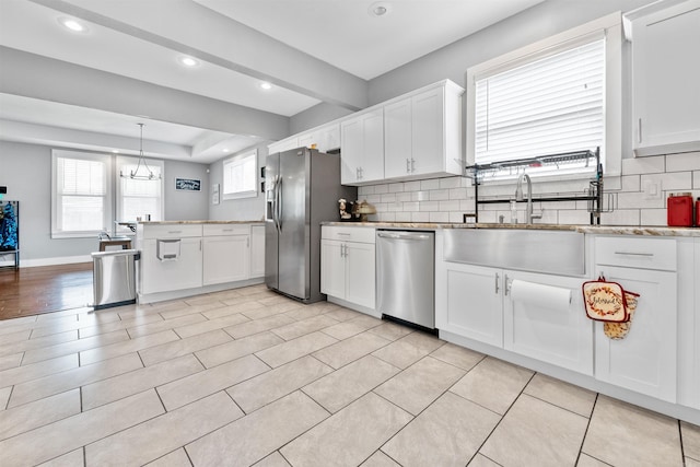 219 W D Ave, North Little Rock, AR 72116 - kitchen featuring appliances with stainless steel finishes, backsplash, recessed lighting, white cabinetry, and a sink