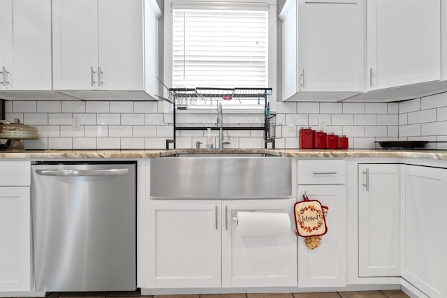 219 W D Ave, North Little Rock, AR 72116 - kitchen with stainless steel dishwasher, a sink, white cabinets, and tasteful backsplash