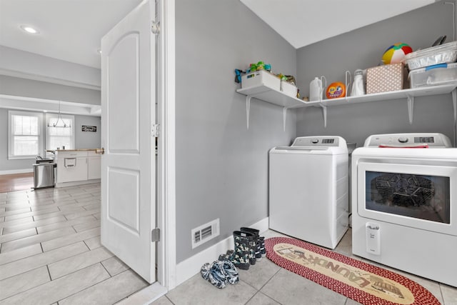 219 W D Ave, North Little Rock, AR 72116 - laundry area featuring washer and dryer, light tile patterned floors, a chandelier, baseboards, and recessed lighting