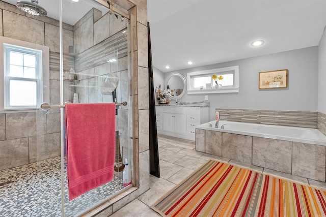 219 W D Ave, North Little Rock, AR 72116 - bathroom with vanity, a shower stall, a bath, and recessed lighting