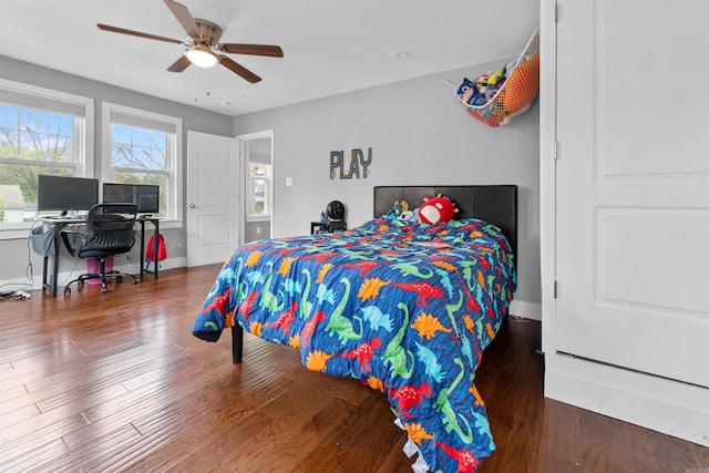 219 W D Ave, North Little Rock, AR 72116 - bedroom with wood finished floors, baseboards, an office area, and a ceiling fan