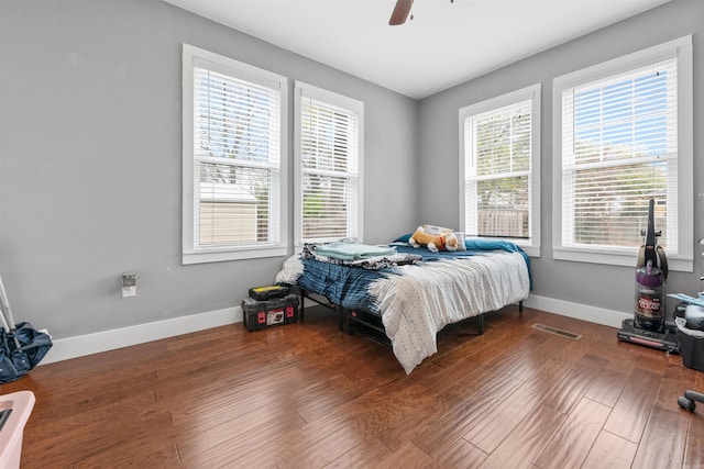219 W D Ave, North Little Rock, AR 72116 - bedroom featuring baseboards, wood finished floors, and ceiling fan